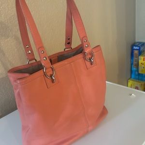 Coral color coach leather handbag with outer pocket